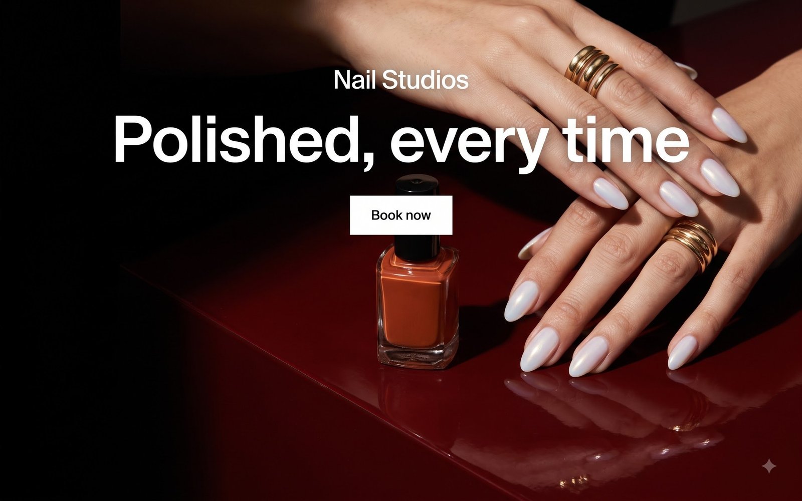 A redesigned nail studio website with a full-bleed editorial photograph of manicured hands on a deep oxblood surface