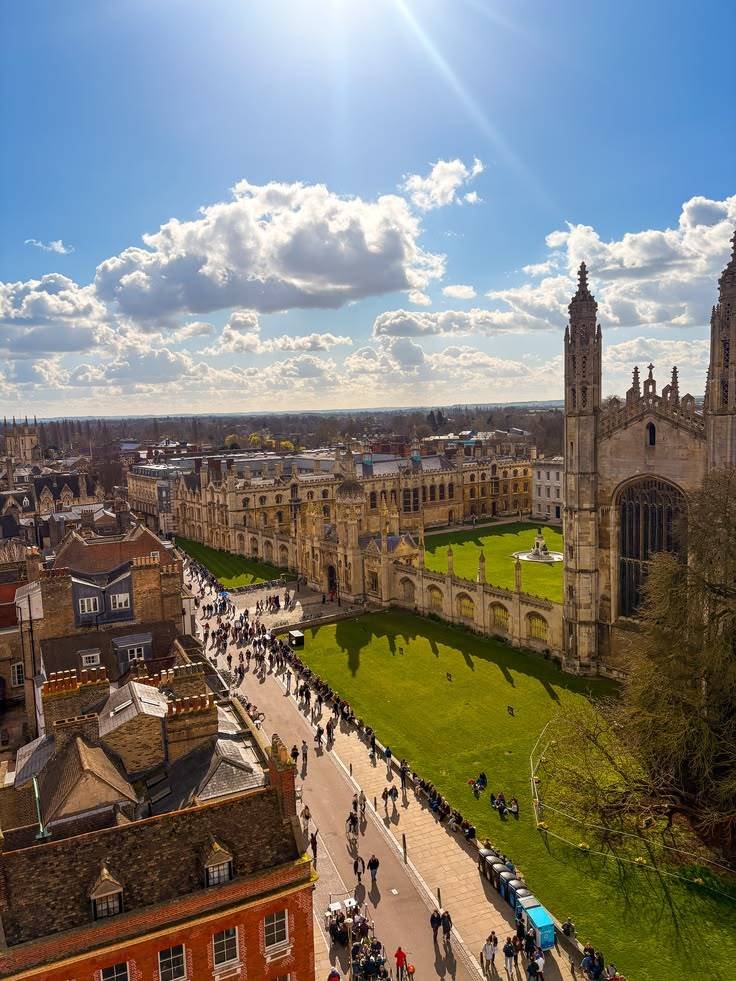 Aerial view over a historic university campus, chapel and college courts in sunlight