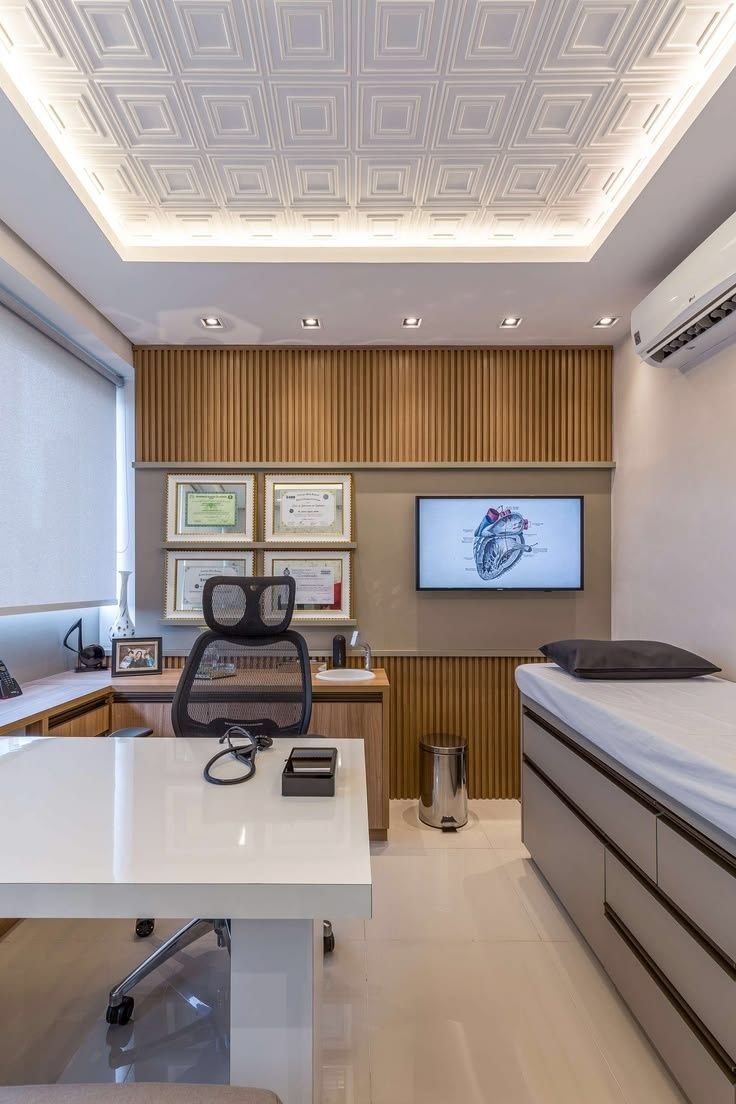 Physiotherapy consultation room with an exam bed, treatment chair and wall-mounted anatomy display, representing a Shantha Hi Tech physiotherapy clinic client